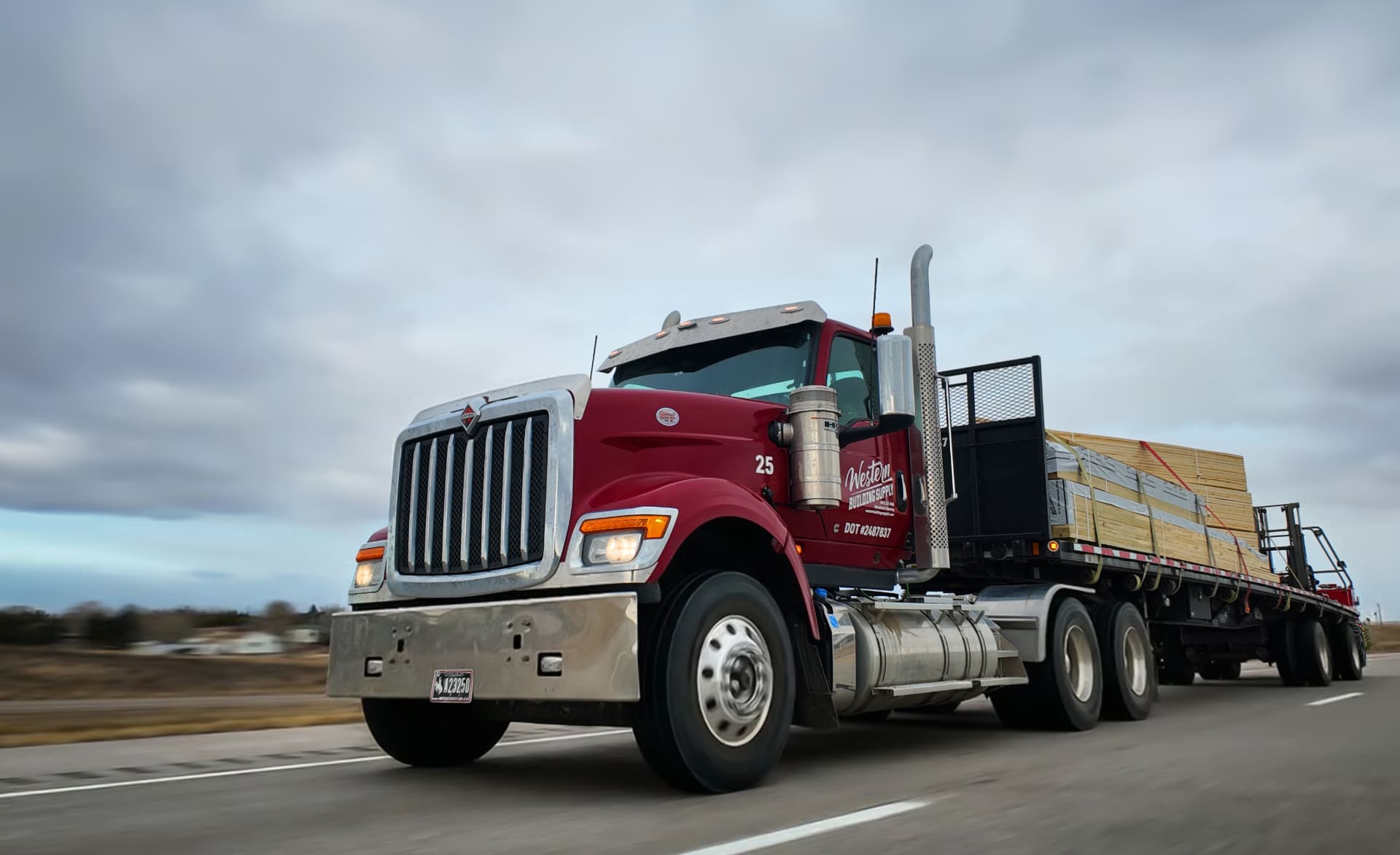 Western Building Supply delivery truck hauling post-frame materials