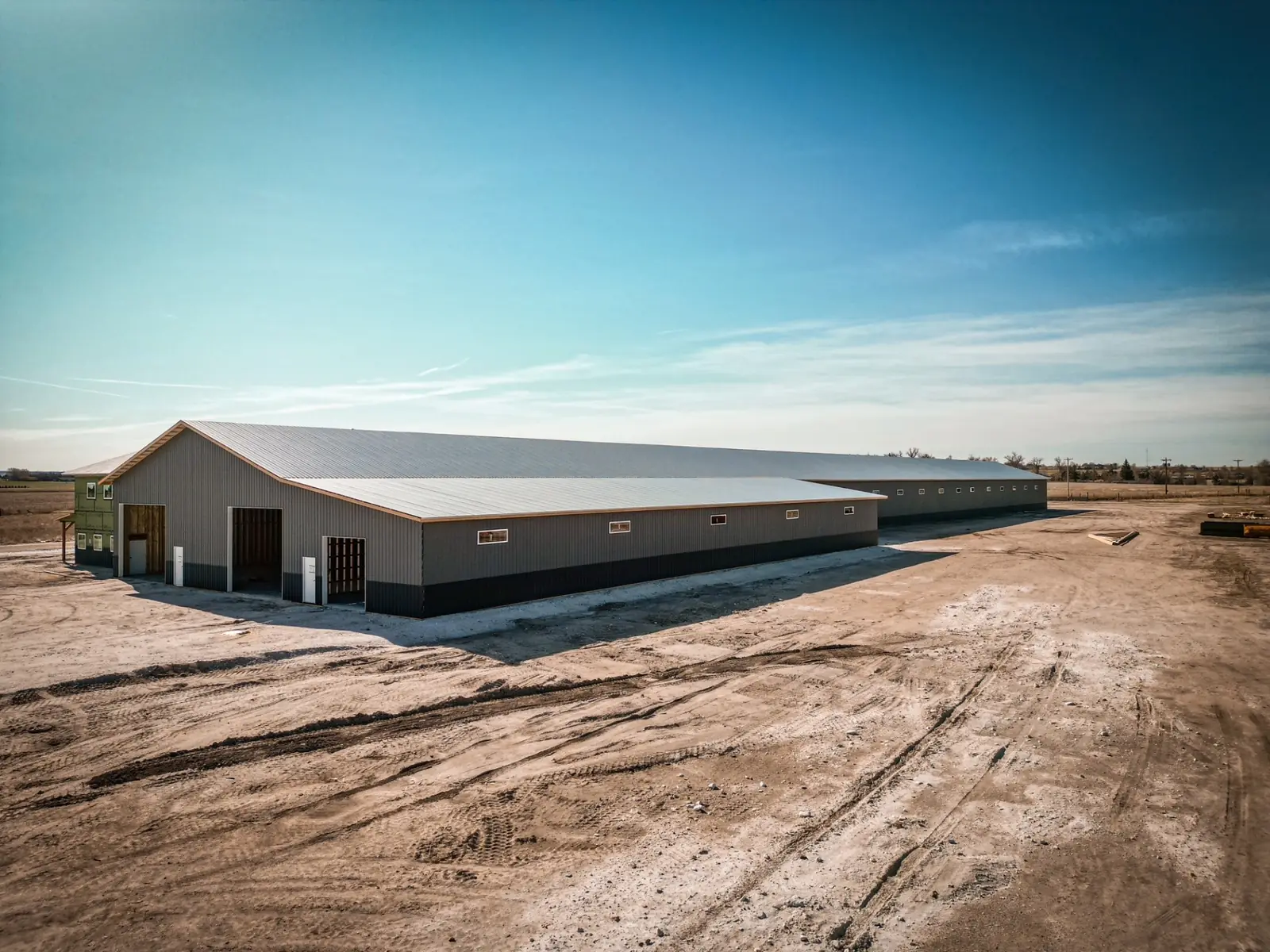 Long post-frame machinery building with steel siding