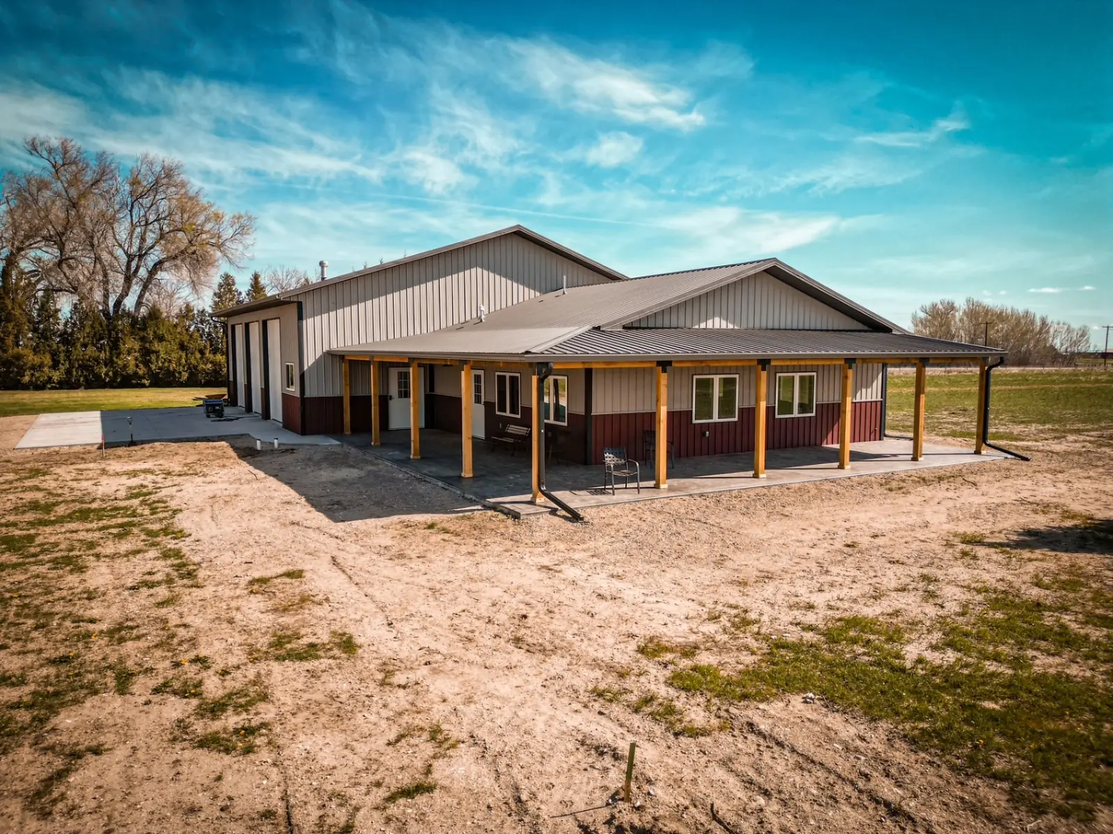 30x40-class post-frame shop with a wraparound porch on timber posts